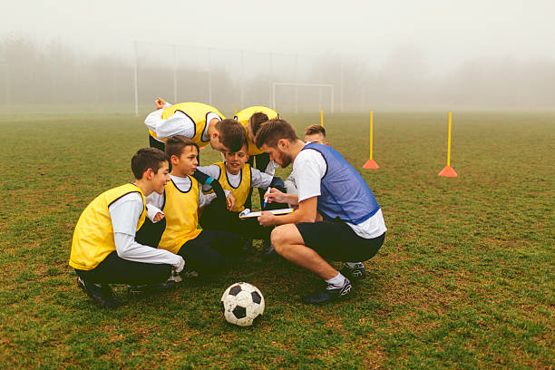 istock Kids Talking With Coach About Soccer Strategy 515264486