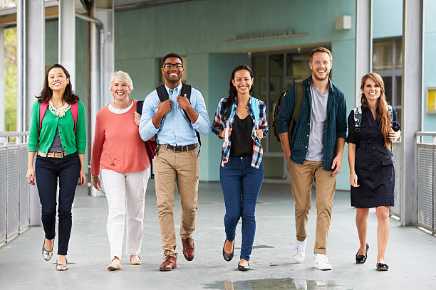 istock A group of happy teachers walking in a school corridor 515264788