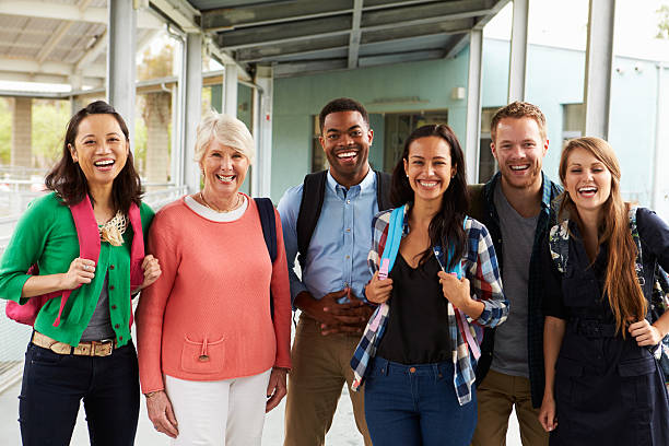 A group of cheerful teachers hanging out in school corridor A group of cheerful teachers hanging out in school corridor instructor stock pictures, royalty-free photos & images