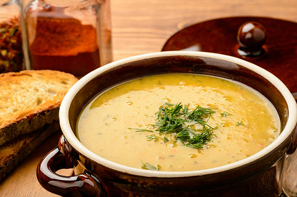 istock Pea cream soup in brown ceramic pot. 515265066