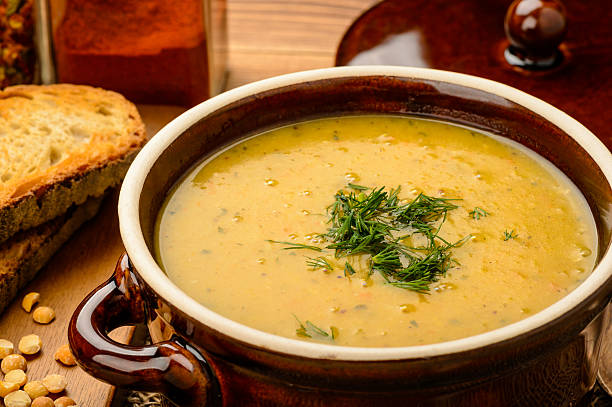 istock Pea cream soup in brown ceramic pot. 515265486