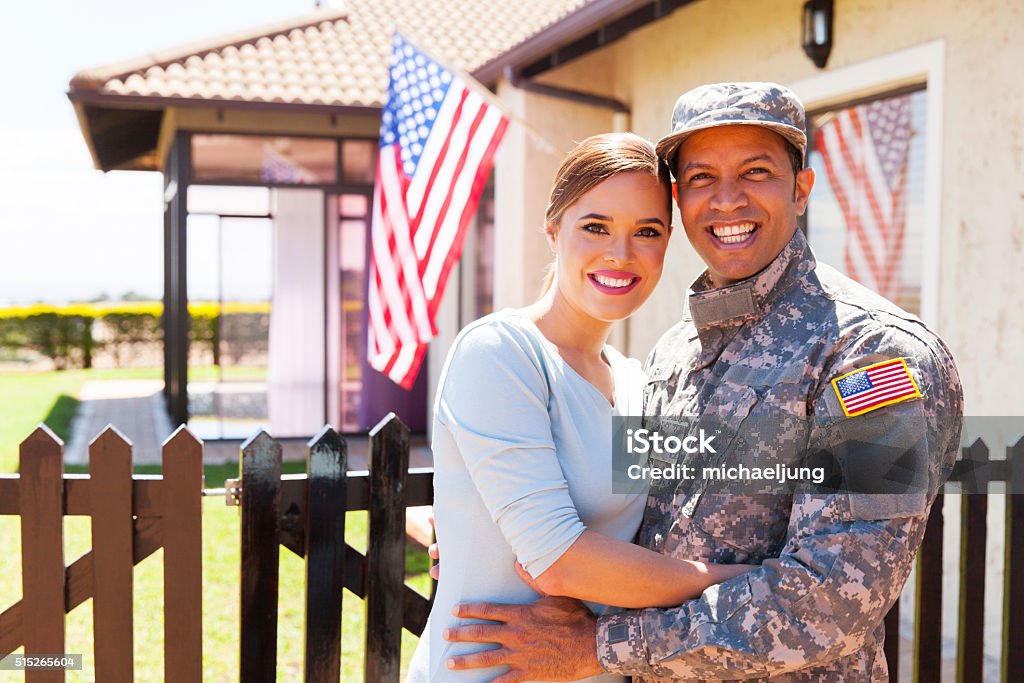 military couple hugging american military couple hugging outside home Veteran Stock Photo