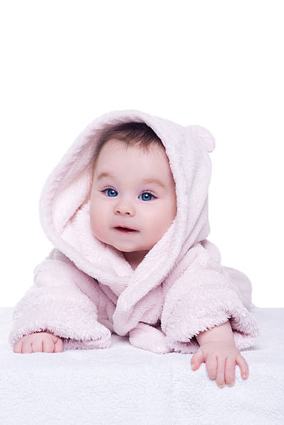 istock cute baby child in pink bathrobe lying down on blanket 515265632