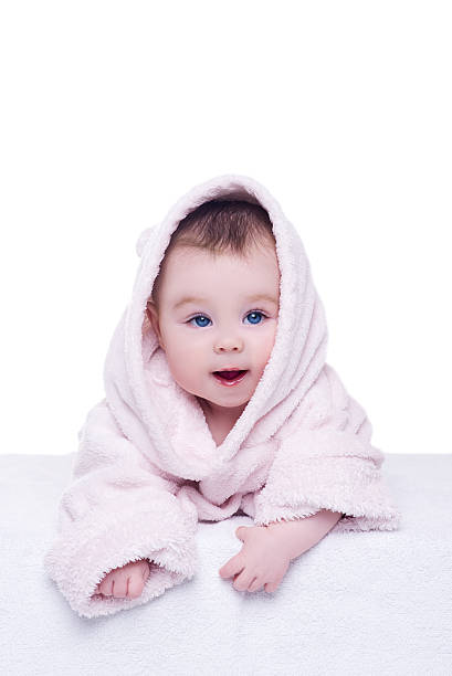 istock cute baby child in pink bathrobe lying down on blanket 515266652