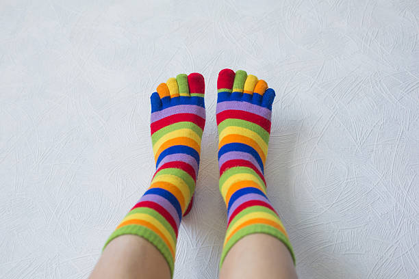 istock Close-up photo woman's feet in multi color socks 515268666