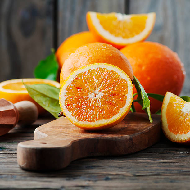 istock Fresh sweet oranges on the wooden table 515269694