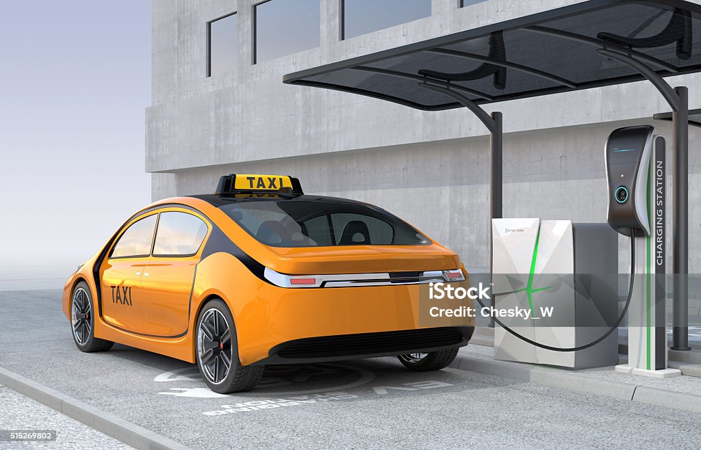Yellow electric taxi charging in charging station Yellow electric taxi charging in charging station. The charging station supply by solar panel and battery. Taxi Stock Photo