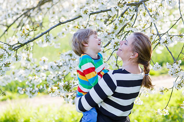 istock Young mum and little kid boy in blooming garden 515270086
