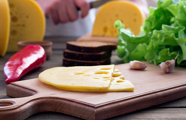 Slice of cheese , herbs and bread Slice of cheese , herbs and bread on a cutting board sandwich new hampshire stock pictures, royalty-free photos & images