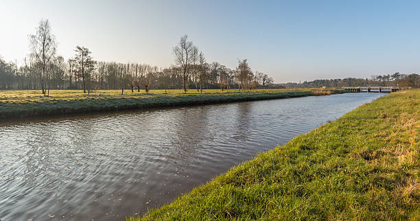 istock Narrow canalised river on an early winter morning 515271244