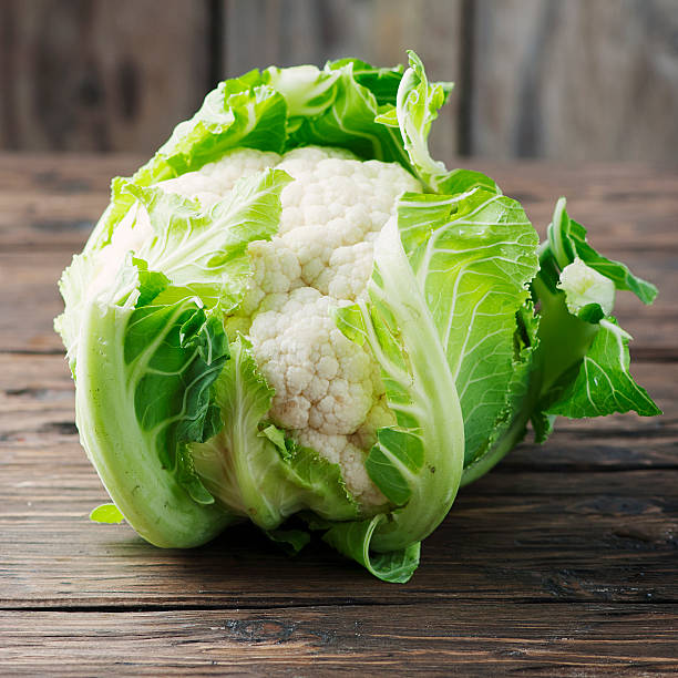 istock Fresh raw cauliflower on the wooden table 515271896