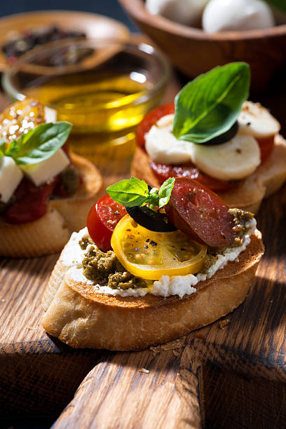 istock Italian appetizers - various bruschettas, closeup vertical 515272404