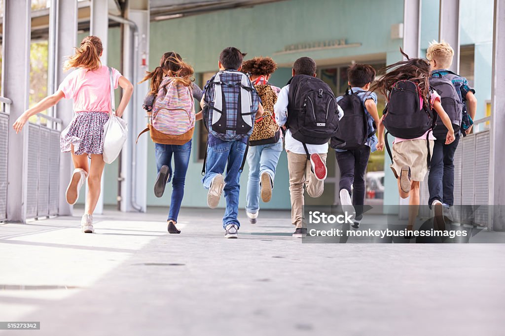 Gruppe der Grundschulkinder, die in der Schule laufen, Rückblick - Lizenzfrei Schulgebäude Stock-Foto