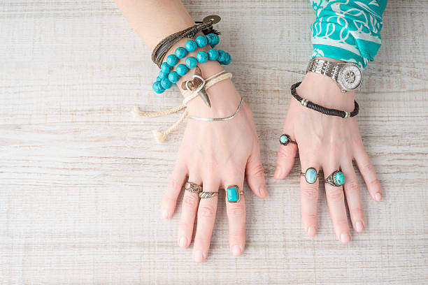 Hands of women in the jewelry of turquoise stock photo