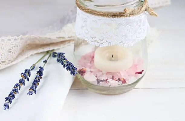 Glass jar, herbal salt, lace, lavender twigs.