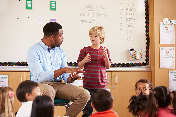 istock Schoolboy at the front of elementary class with teacher 515274450