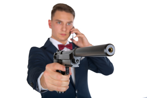 Confident businessman pointing a gun on isolated background