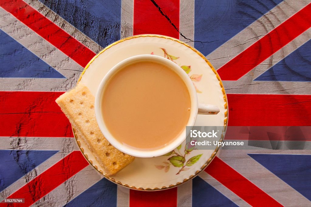 British Cuppa The Union Jack flag with a cup of tea served with a shortbread biscuit in a bone china cup and saucer Tea - Hot Drink Stock Photo