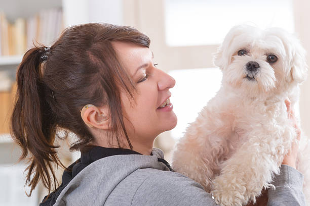 istock Woman wearing deaf aid with her dog 515275918