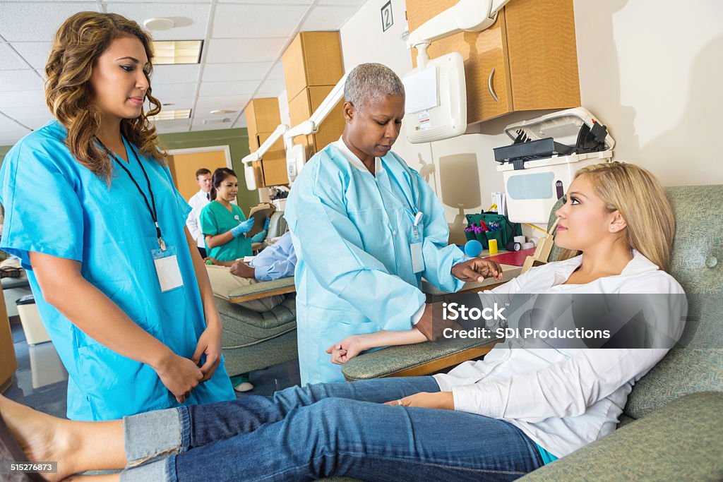 Senior nurse checking on patient who is donating blood Busy Stock Photo