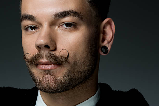 istock close up of young man with long moustaches 515276935