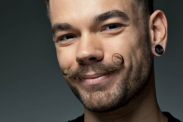 istock close up of young man with long moustaches 515276969