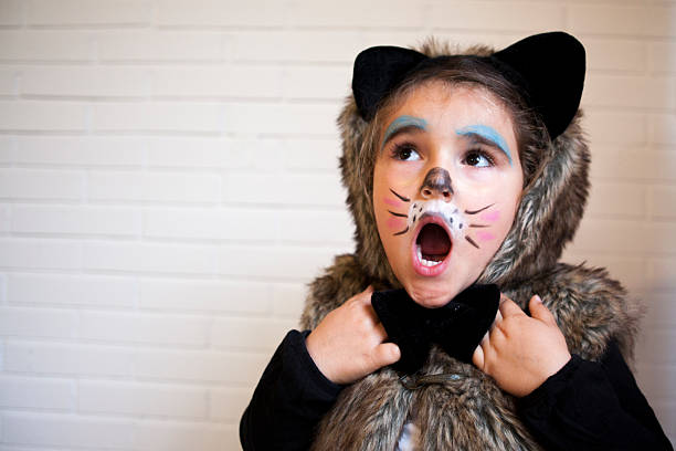 Girl with a cat costume Girl with a cat costume in Halloween halloween face paint stock pictures, royalty-free photos & images
