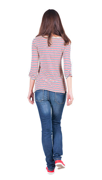 istock back view of walking  woman in jeans . 515277725