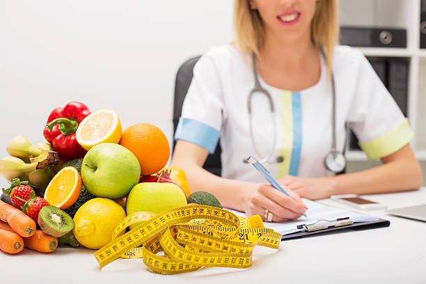 istock Tape measure and vegetables on doctors table 515278394