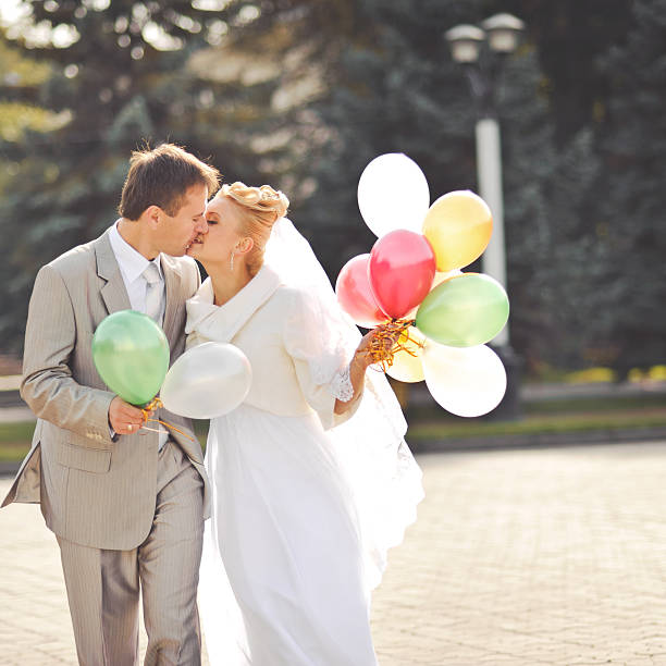 istock Young newlywed couple with balloons. 515279567