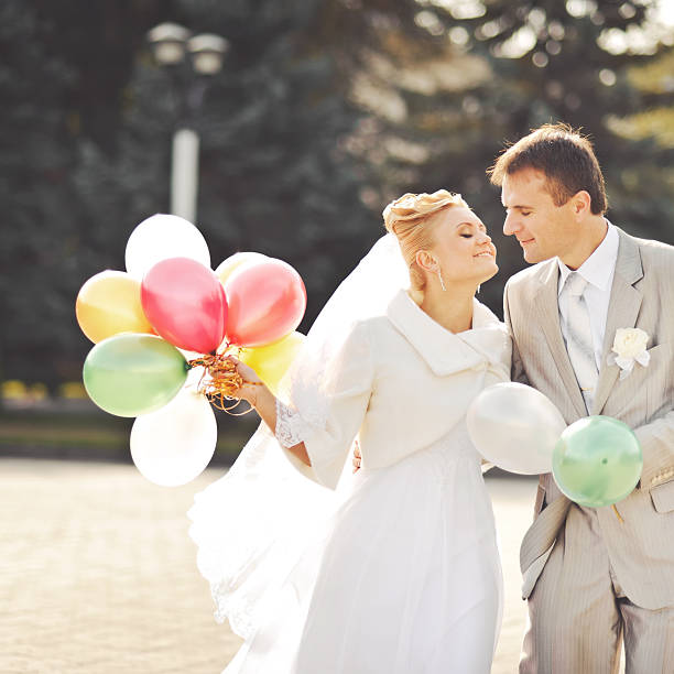 istock Young newlywed couple with balloons. 515279745