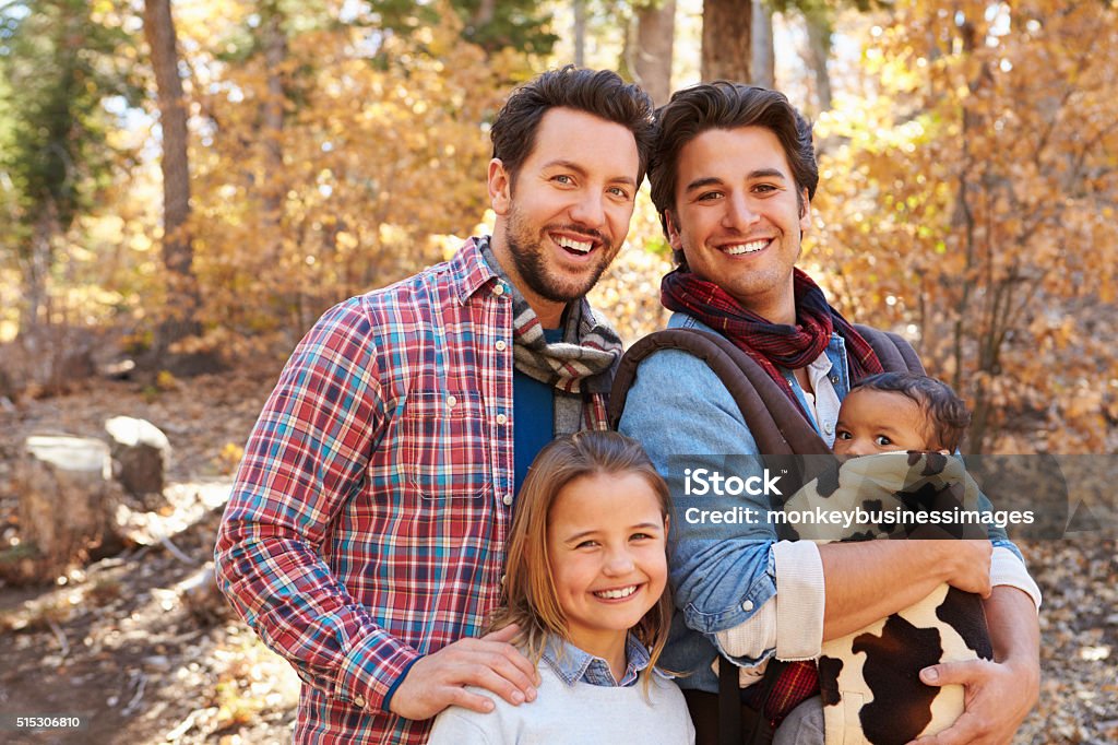 Gay Male Couple With Children Walking Through Fall Woodland Gay Person Stock Photo