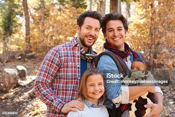 Gay Male Couple With Children Walking Through Fall Woodland Stock Photo - Download Image Now