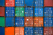 Four vertical rows of shipping containers