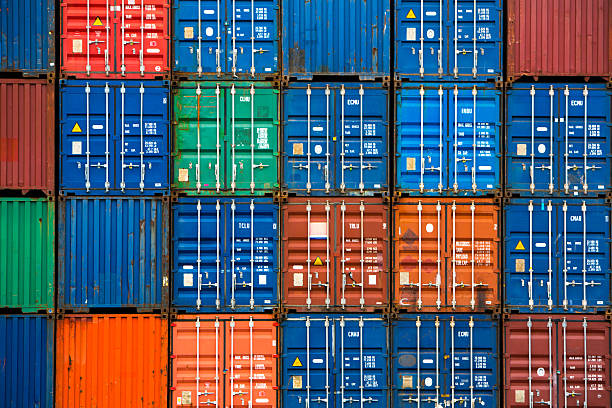 Four vertical rows of shipping containers stock photo