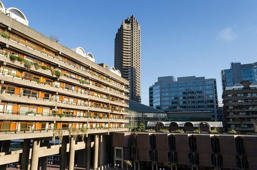 Brutalist concrete architecture of the Barbican residential estate in central London. The Barbican complex also contains the Barbican Centre, a multi-arts and conference venue that is home to the London Symphony Orchestra.