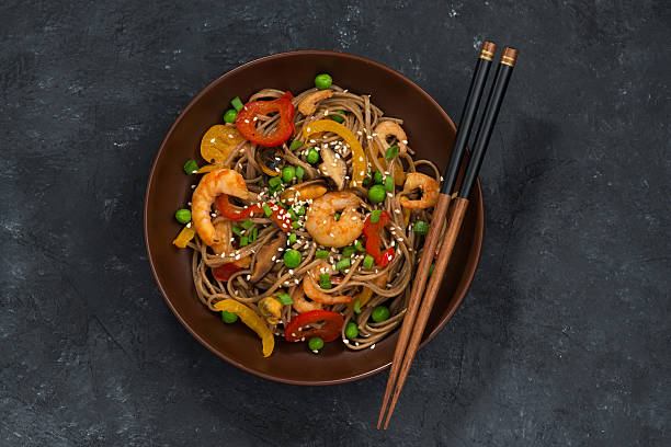 istock Buckwheat noodles with seafood in a bowl, top view 515308854