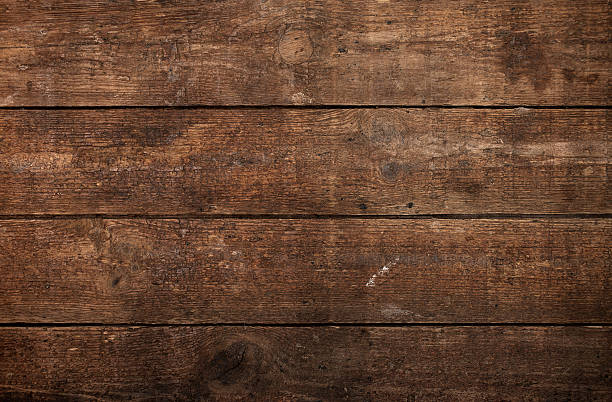Overhead view of brown wooden table A wood background with multiple planks placed close together.  The planks feature a variety of light and dark brown shades.  half timbered photos stock pictures, royalty-free photos & images