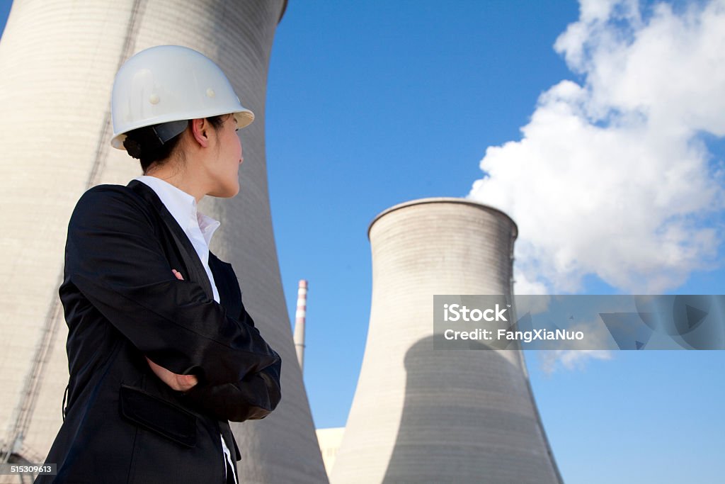 Engineer in front of cooling towers Nuclear Power Station Stock Photo