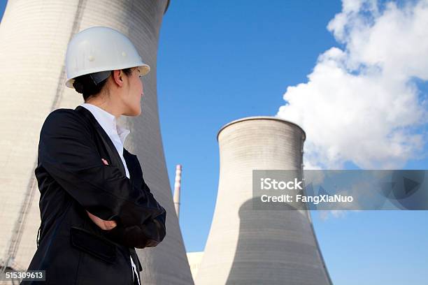 Engineer In Front Of Cooling Towers Stock Photo - Download Image Now - Nuclear Power Station, Engineer, Cooling Tower