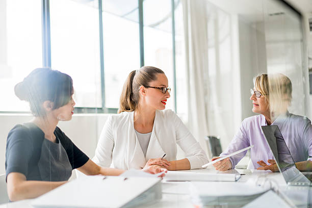 istock Businesswomen discussing at desk in office 515310026