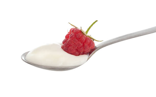 istock Spoonful of natural organic yoghurt, isolated on white. 515310087