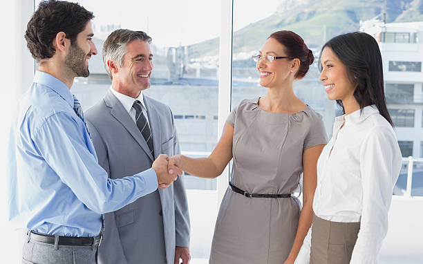 istock Two fellow employees shaking hands 515310719