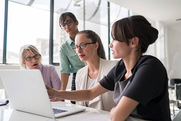 istock Businesswomen using laptop together at desk 515312178