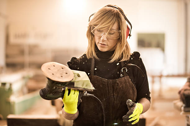 istock Blonde woman holding power sander 515313280