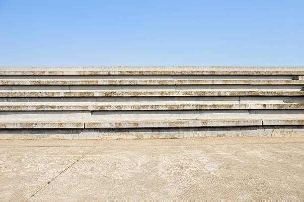 sports facilities in the city cement bleachers seats in an urban with blue sky background in sport centre outdoor staircase stock pictures, royalty-free photos & images