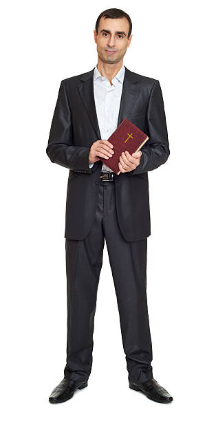 istock Man portrait in suit with book on white at studio 515314976