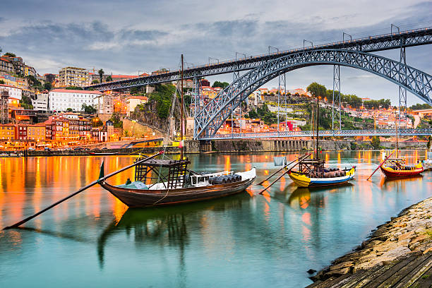 Porto Portugal on the Douro River Porto, Portugal old town skyline on the Douro River with rabelo boats. rabelo boat stock pictures, royalty-free photos & images