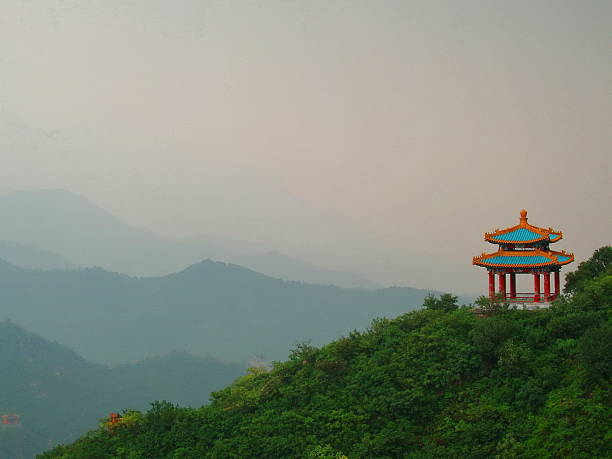 Empty square brick floor and red wall with mountains scenery