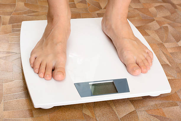 istock female feet standing on the scale 515320608